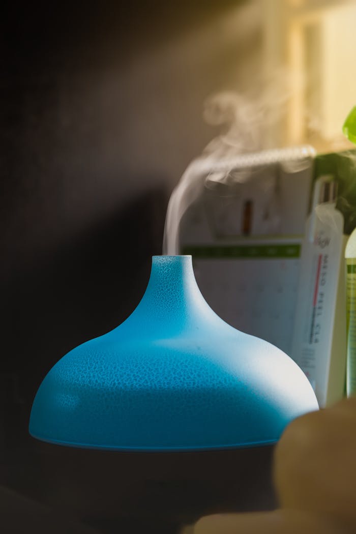 our-services-1 Close-up of a blue humidifier releasing vapor, creating a serene indoor atmosphere.