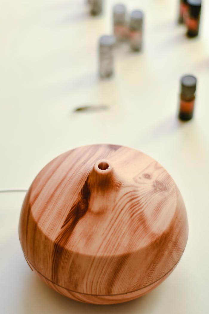 our-services-2 A wooden aroma diffuser surrounded by essential oil bottles on a light background.