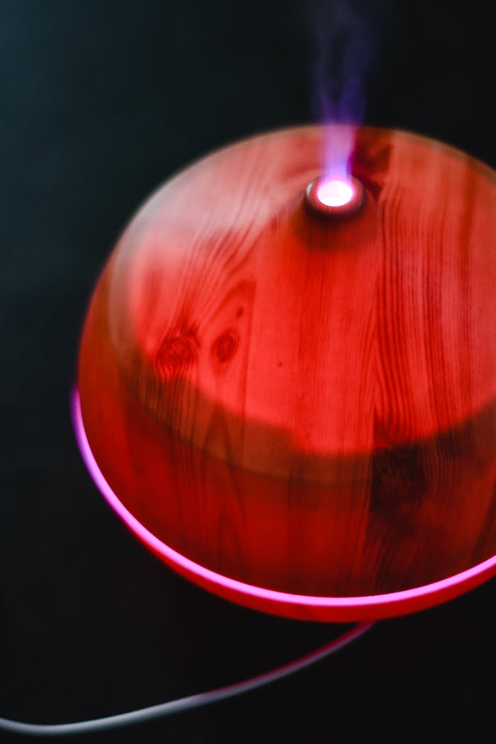 about-01 Close-up of a wooden diffuser emitting a soothing aroma with soft LED lighting.